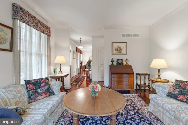 a kitchen with stainless steel appliances granite countertop a refrigerator a stove top oven a sink dishwasher and wooden floor