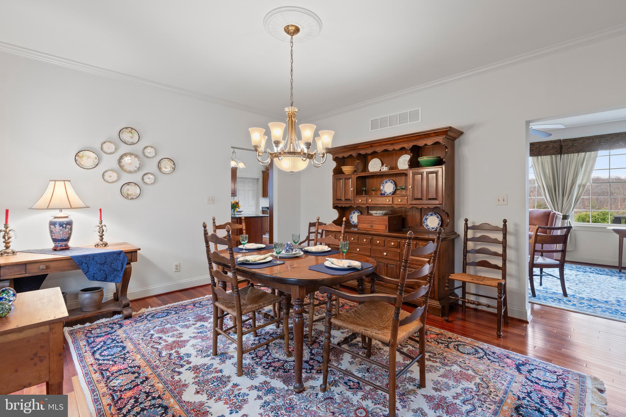 2183 Amoss Mill Road Pylesville, MD 21132 - Photo 19 of 90 a view of a dining room with furniture wooden floor and a chandelier