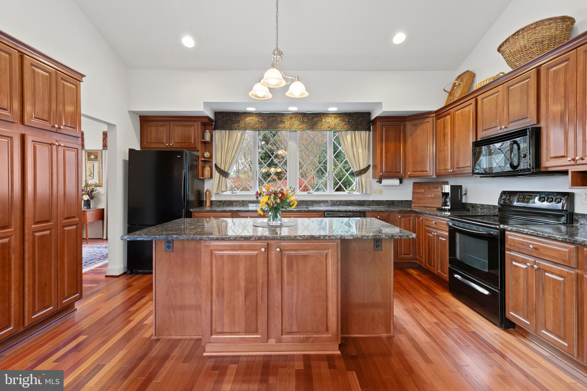 2183 Amoss Mill Road Pylesville, MD 21132 - Photo 27 of 90 a kitchen with stainless steel appliances granite countertop a refrigerator a stove top oven a sink dishwasher and wooden floor