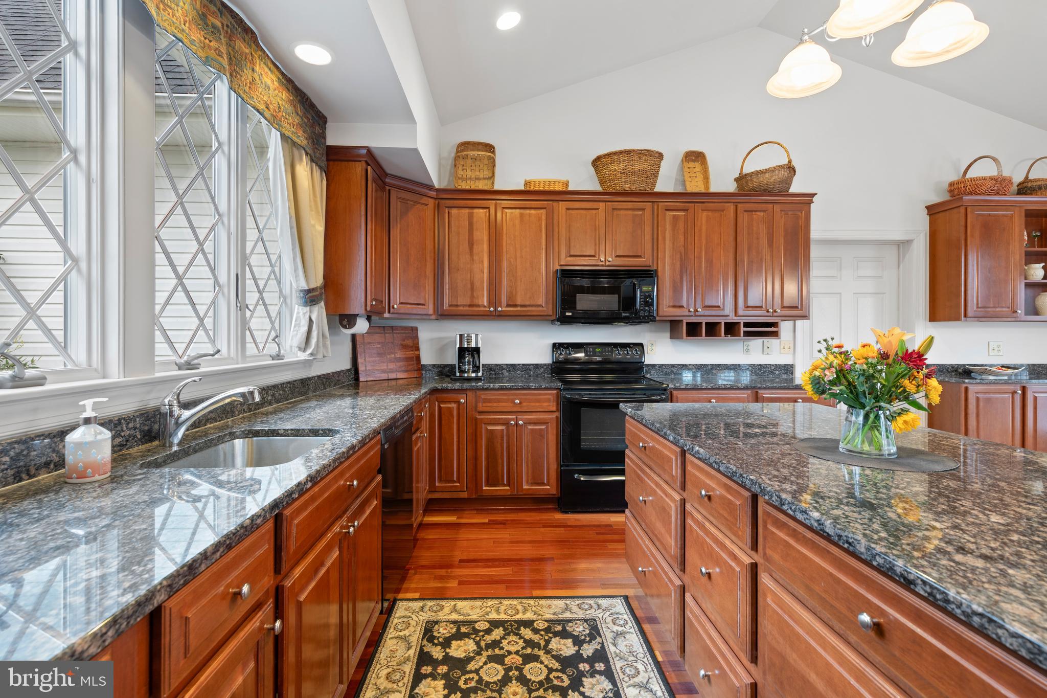 2183 Amoss Mill Road Pylesville, MD 21132 - Photo 28 of 90 a kitchen with stainless steel appliances granite countertop a sink a stove and a wooden cabinets