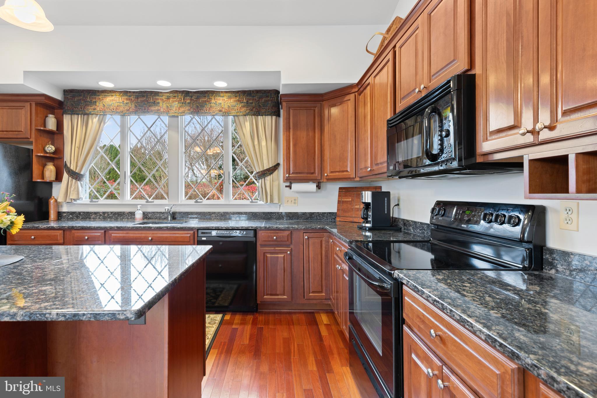 2183 Amoss Mill Road Pylesville, MD 21132 - Photo 30 of 90 a kitchen with stainless steel appliances granite countertop a stove a sink and a microwave