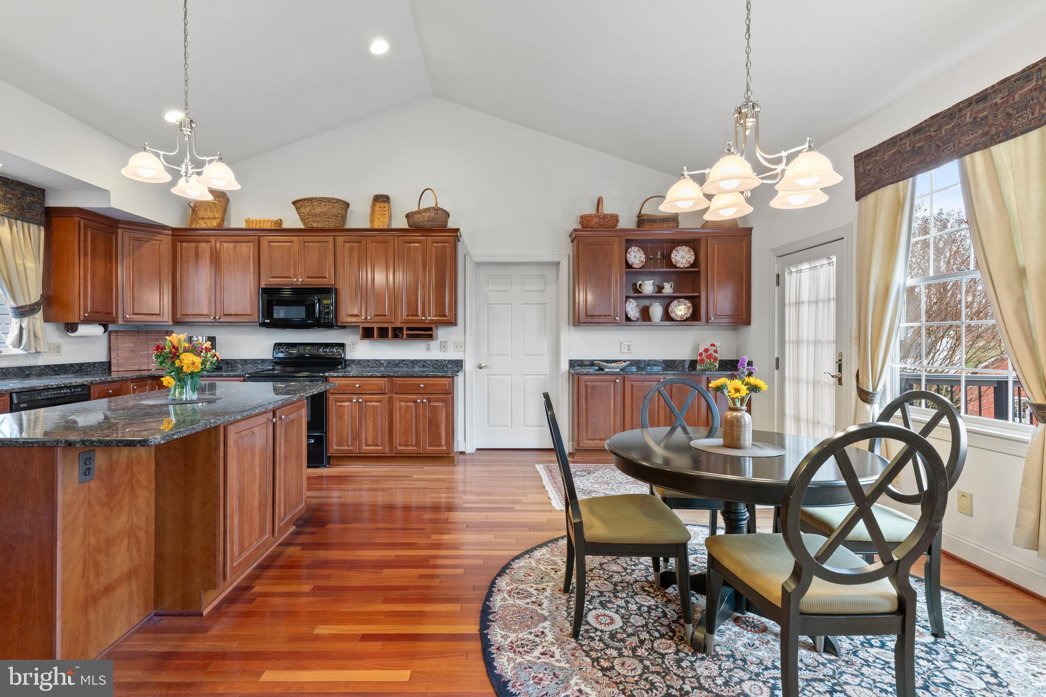 2183 Amoss Mill Road Pylesville, MD 21132 - Photo 33 of 90 a kitchen with stainless steel appliances a table chairs and a refrigerator