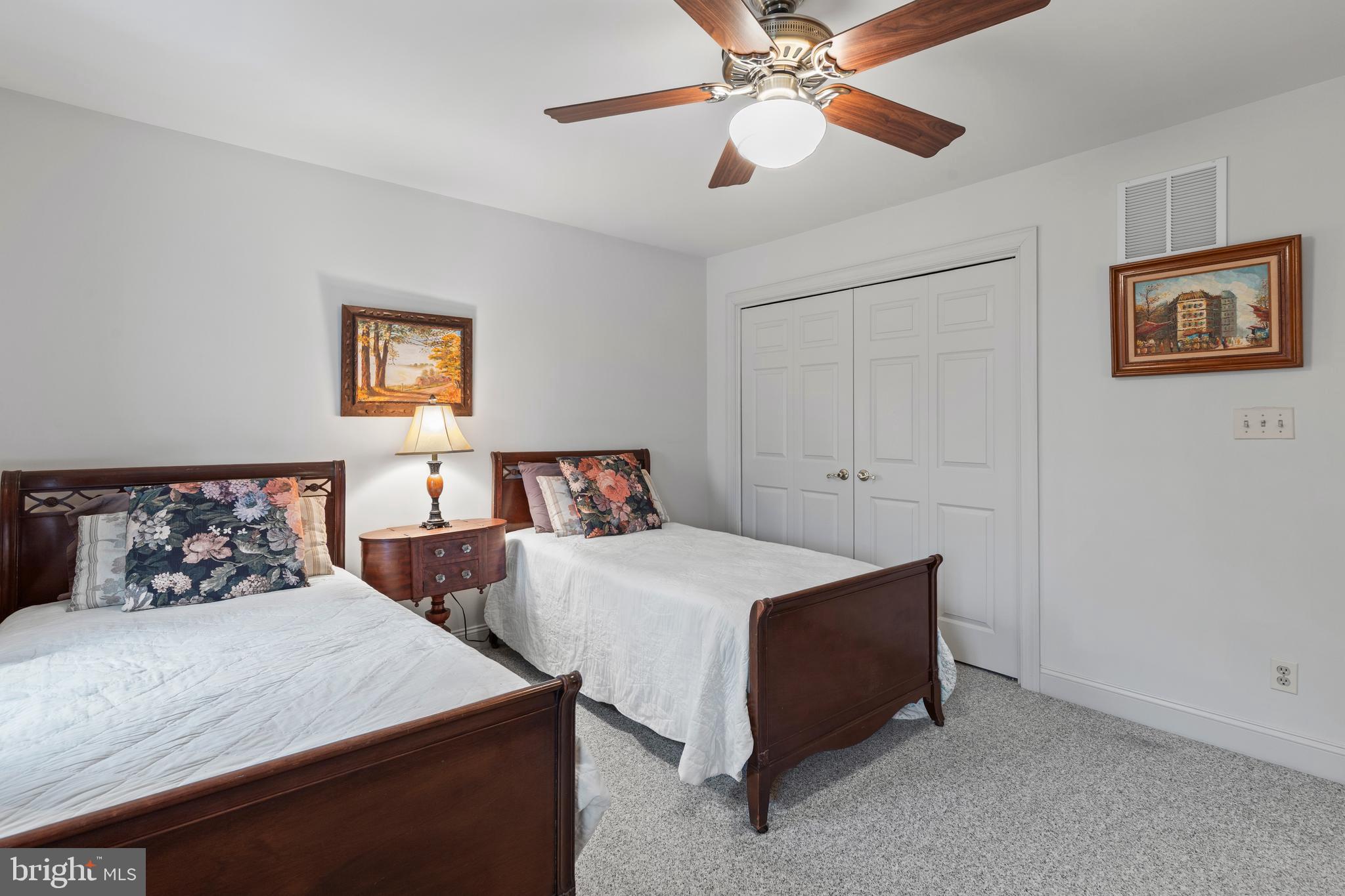2183 Amoss Mill Road Pylesville, MD 21132 - Photo 44 of 90 a bedroom with two beds and a chandelier