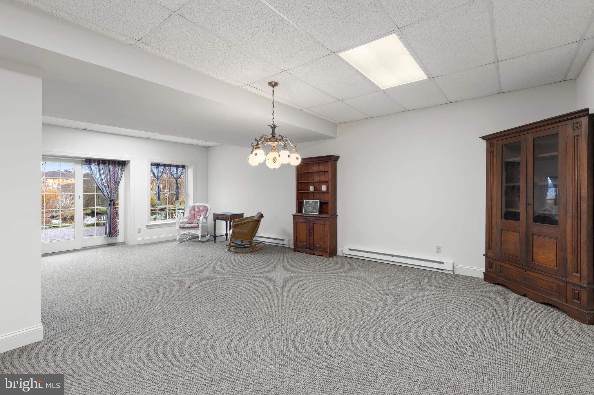 2183 Amoss Mill Road Pylesville, MD 21132 - Photo 50 of 90 a view of a livingroom with a furniture chandelier and windows