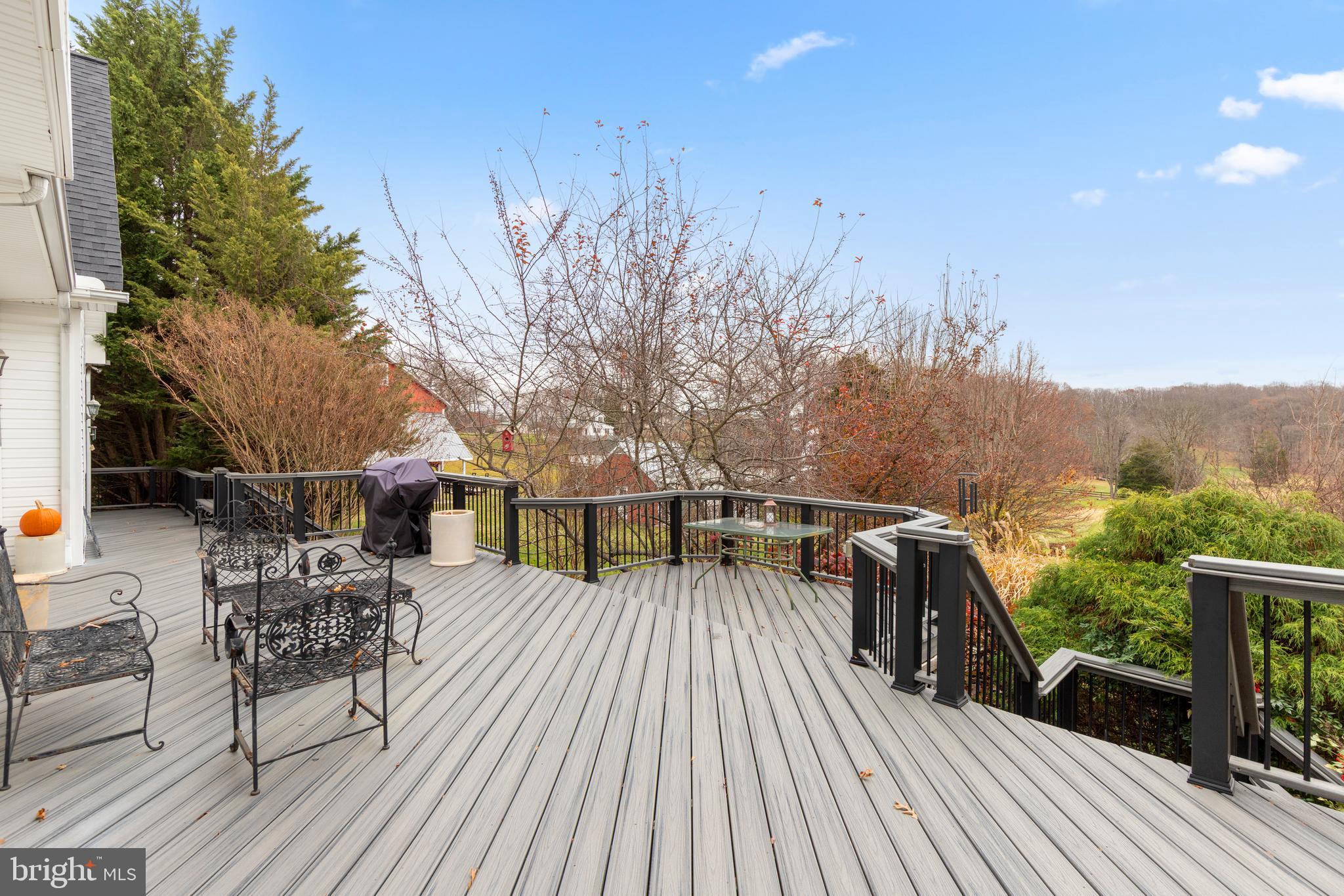 2183 Amoss Mill Road Pylesville, MD 21132 - Photo 57 of 90 a view of a roof deck with table and chairs a barbeque with wooden floor and fence