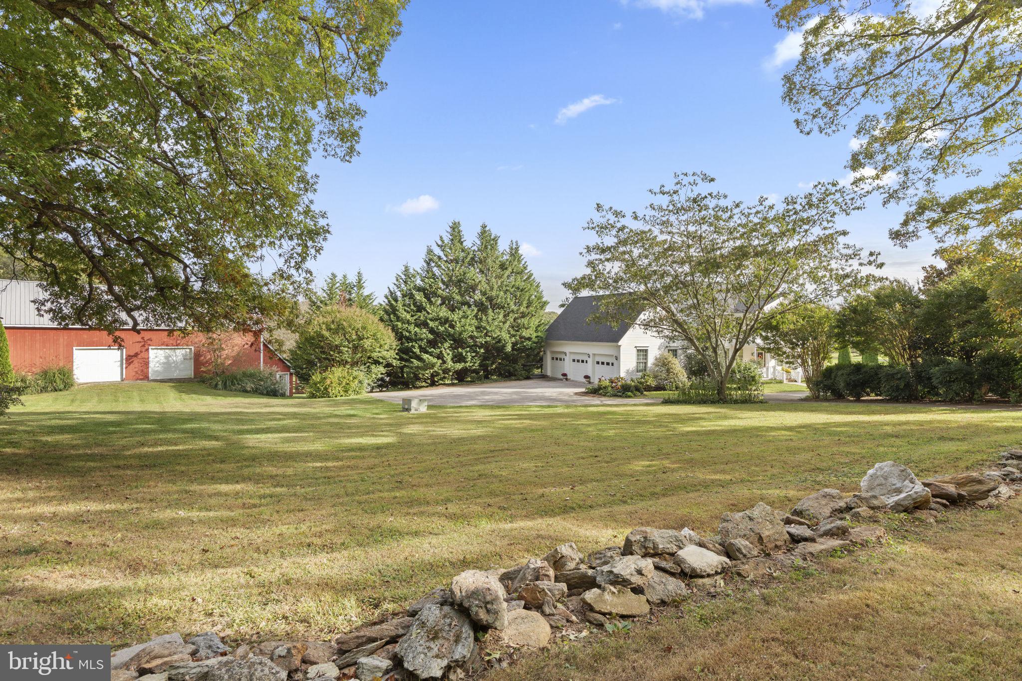 2183 Amoss Mill Road Pylesville, MD 21132 - Photo 75 of 90 Stone wall and view of barns and garage