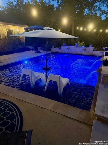 a view of a room with furniture and a chandelier