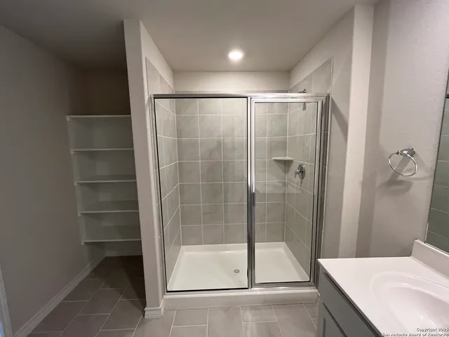 a bathroom with a shower and a sink