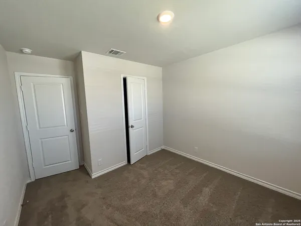 an empty room with closet area