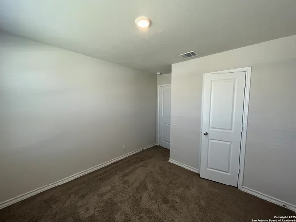 an empty room with closet area