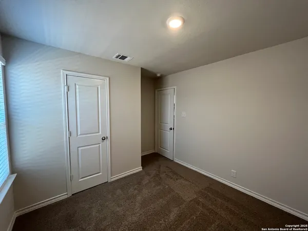 an empty room with closet area