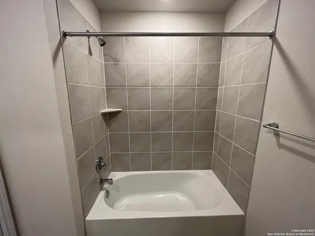 a bath tub sitting next to a shower