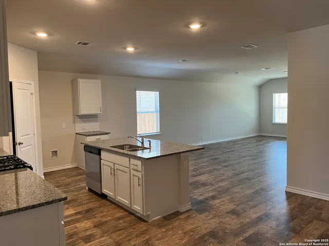 a kitchen with stainless steel appliances granite countertop a stove and a sink