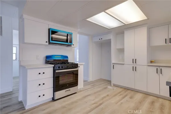 a kitchen with stainless steel appliances white cabinets and a stove