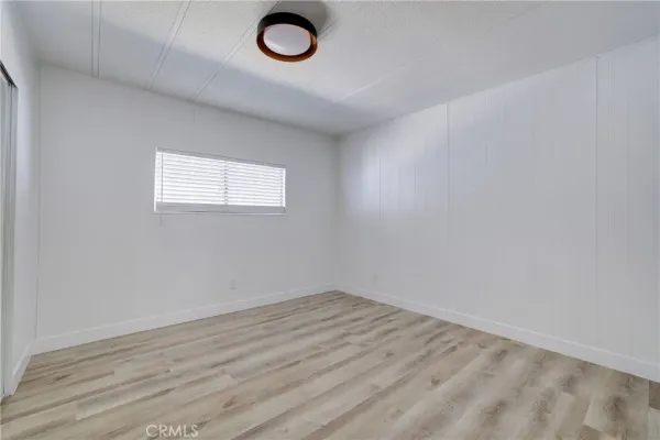 an empty room with wooden floor