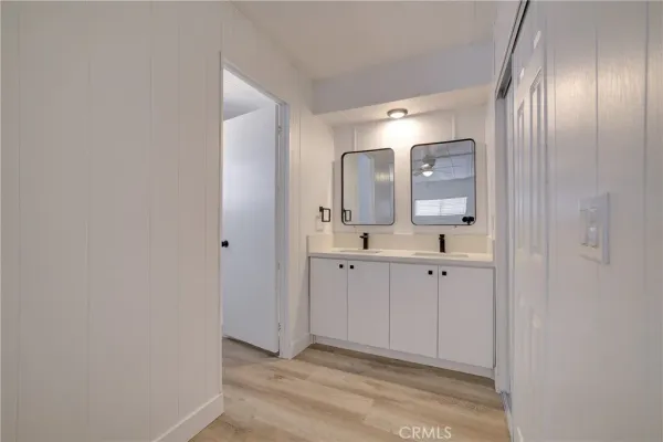 a spacious bathroom with a double vanity sink and mirror
