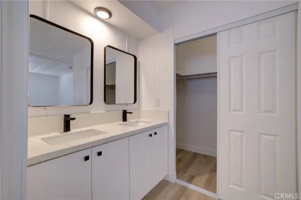 a bathroom with a double vanity sink and mirror