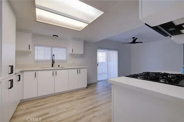 a kitchen with a sink stove and cabinets