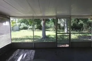 a view of an empty room with a floor to ceiling window