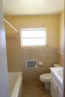 a bathroom with a toilet a sink and bathtub