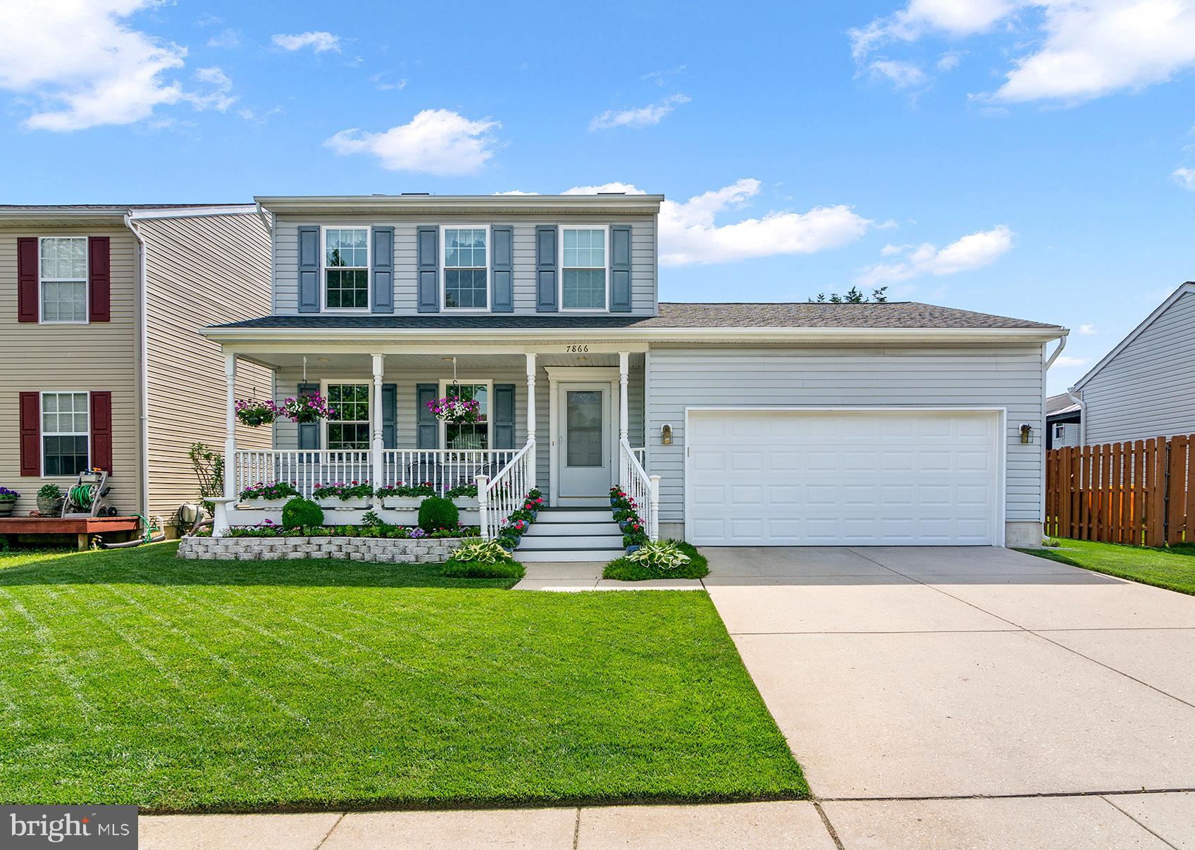 7866 Kings Bench Place Pasadena, MD 21122 - Photo 1 of 51 front view of a house with a yard