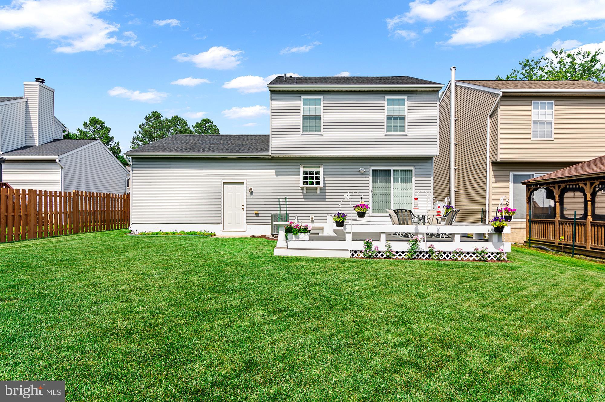 7866 Kings Bench Place Pasadena, MD 21122 - Photo 11 of 51 a view of a house with a yard and sitting area