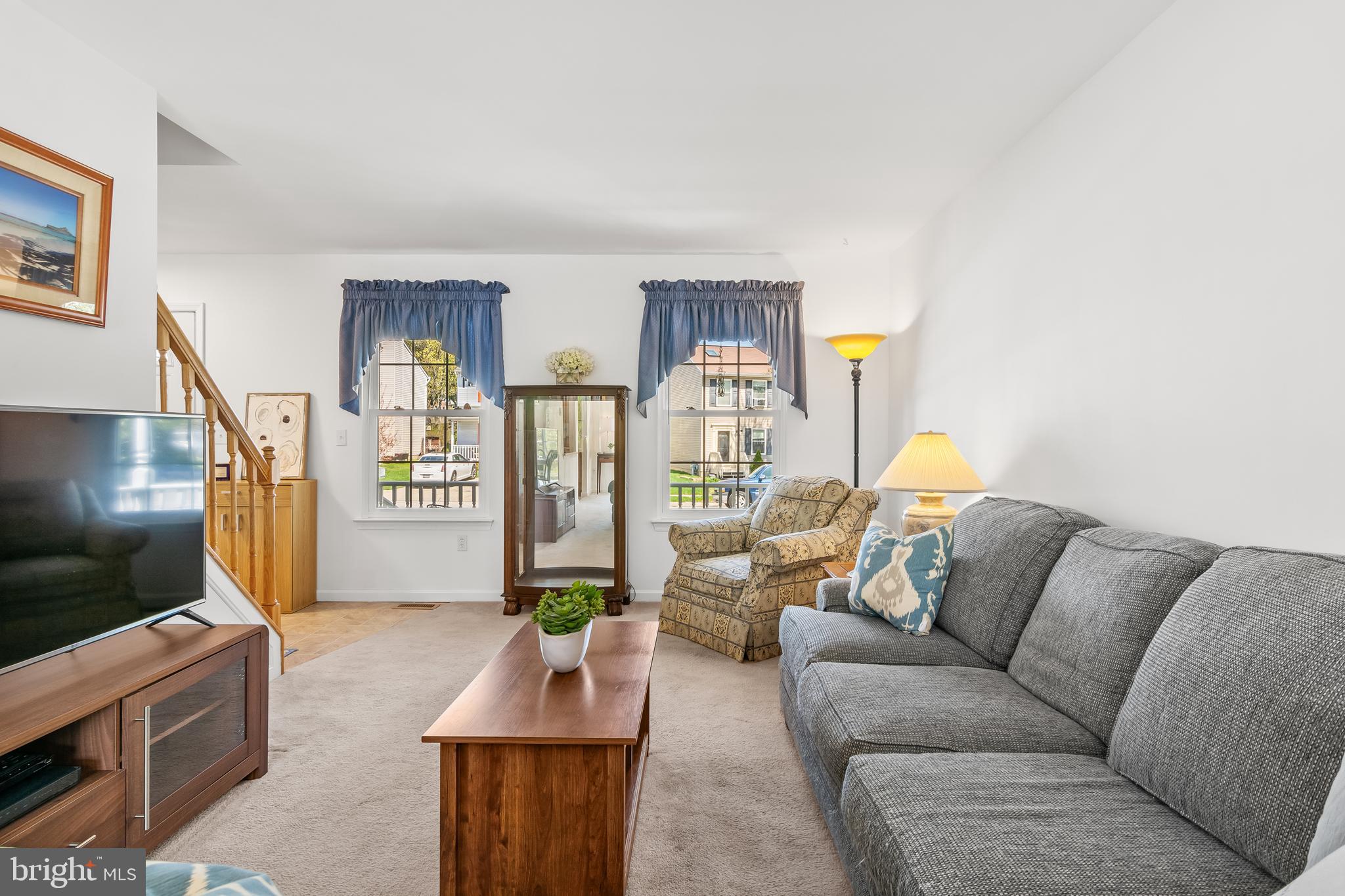 7866 Kings Bench Place Pasadena, MD 21122 - Photo 12 of 51 a living room with furniture and a flat screen tv