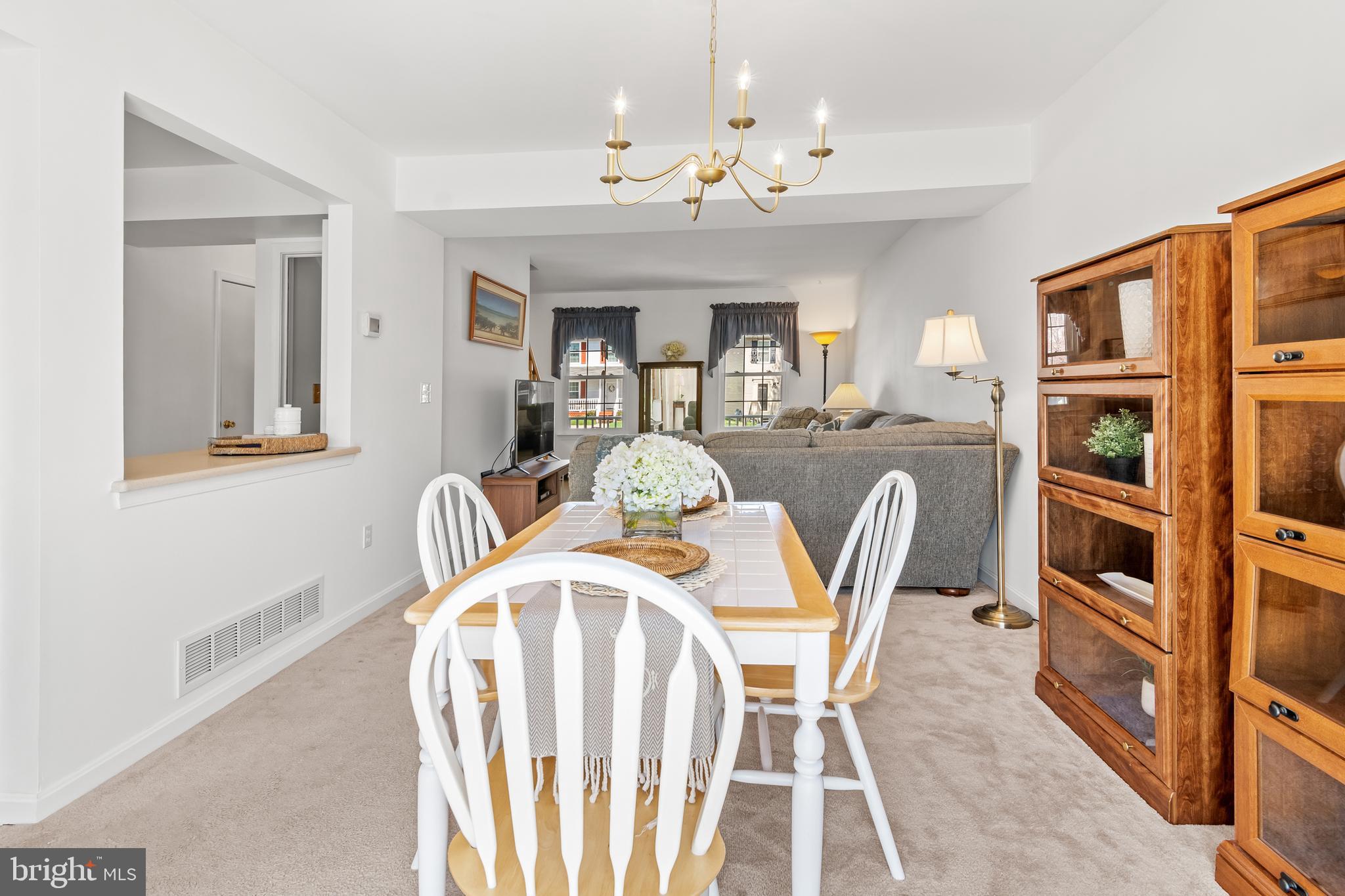 7866 Kings Bench Place Pasadena, MD 21122 - Photo 18 of 51 a view of a dining room with furniture and chandelier