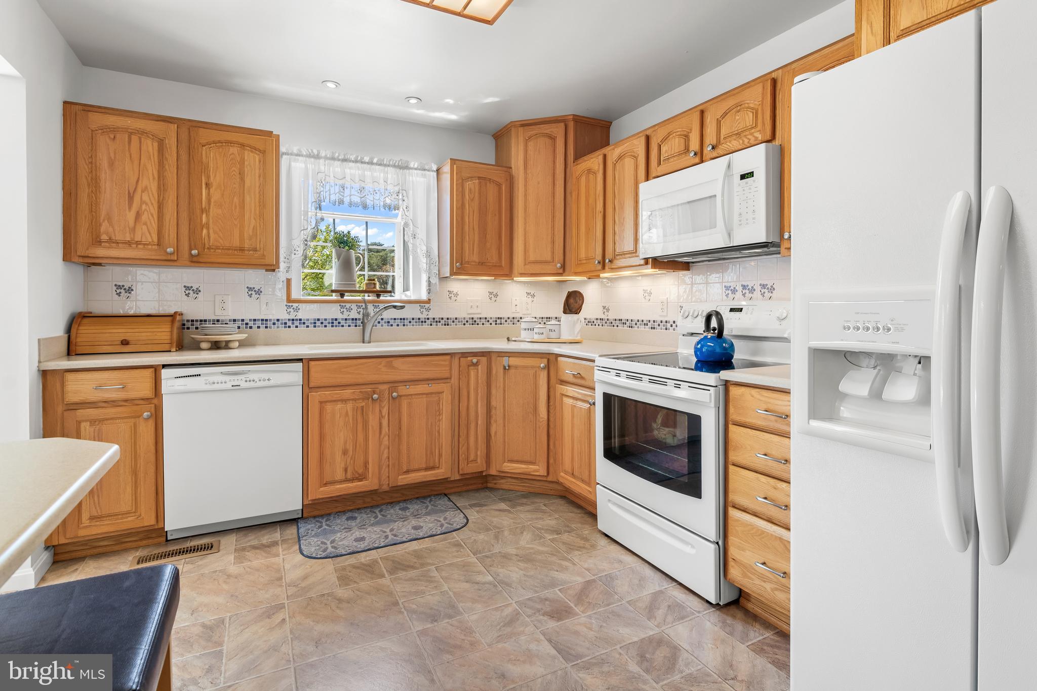 7866 Kings Bench Place Pasadena, MD 21122 - Photo 22 of 51 a kitchen with a stove sink and cabinets