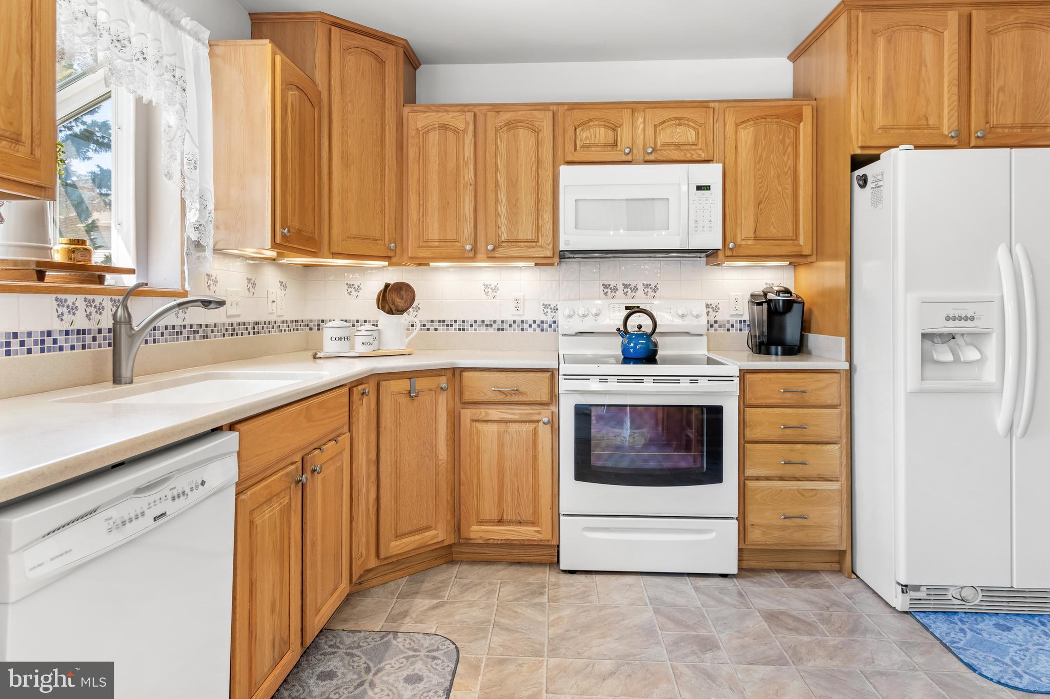 7866 Kings Bench Place Pasadena, MD 21122 - Photo 23 of 51 a kitchen with stainless steel appliances white cabinets and a refrigerator
