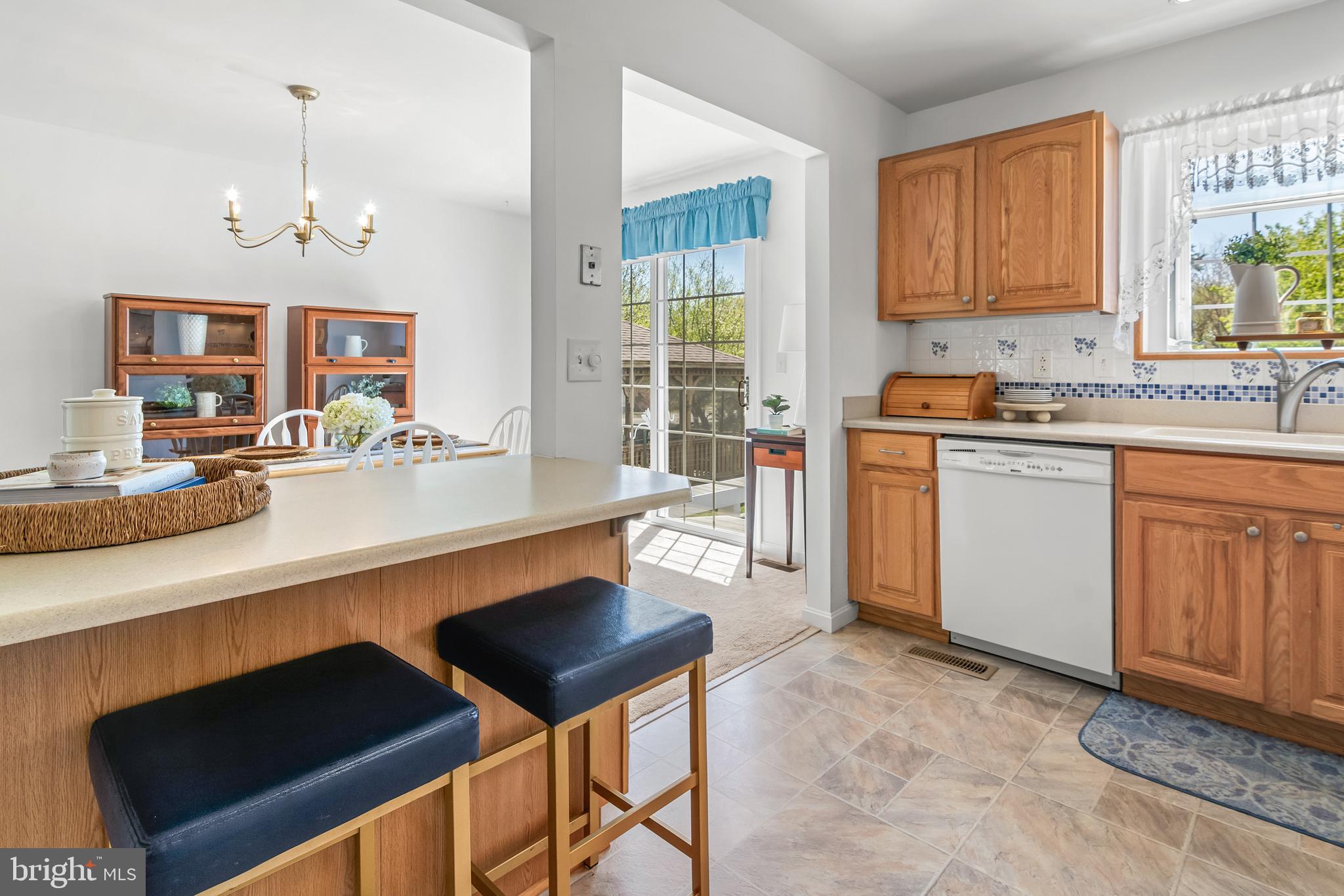7866 Kings Bench Place Pasadena, MD 21122 - Photo 24 of 51 a kitchen with cabinets and chairs