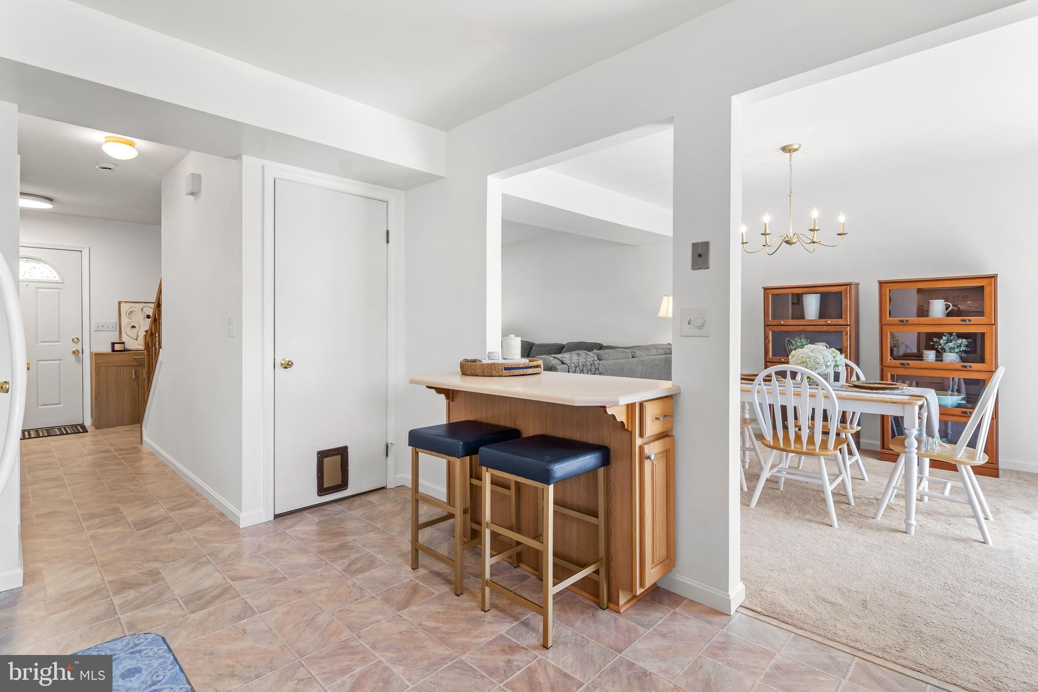 7866 Kings Bench Place Pasadena, MD 21122 - Photo 29 of 51 a kitchen with a table and chairs in it
