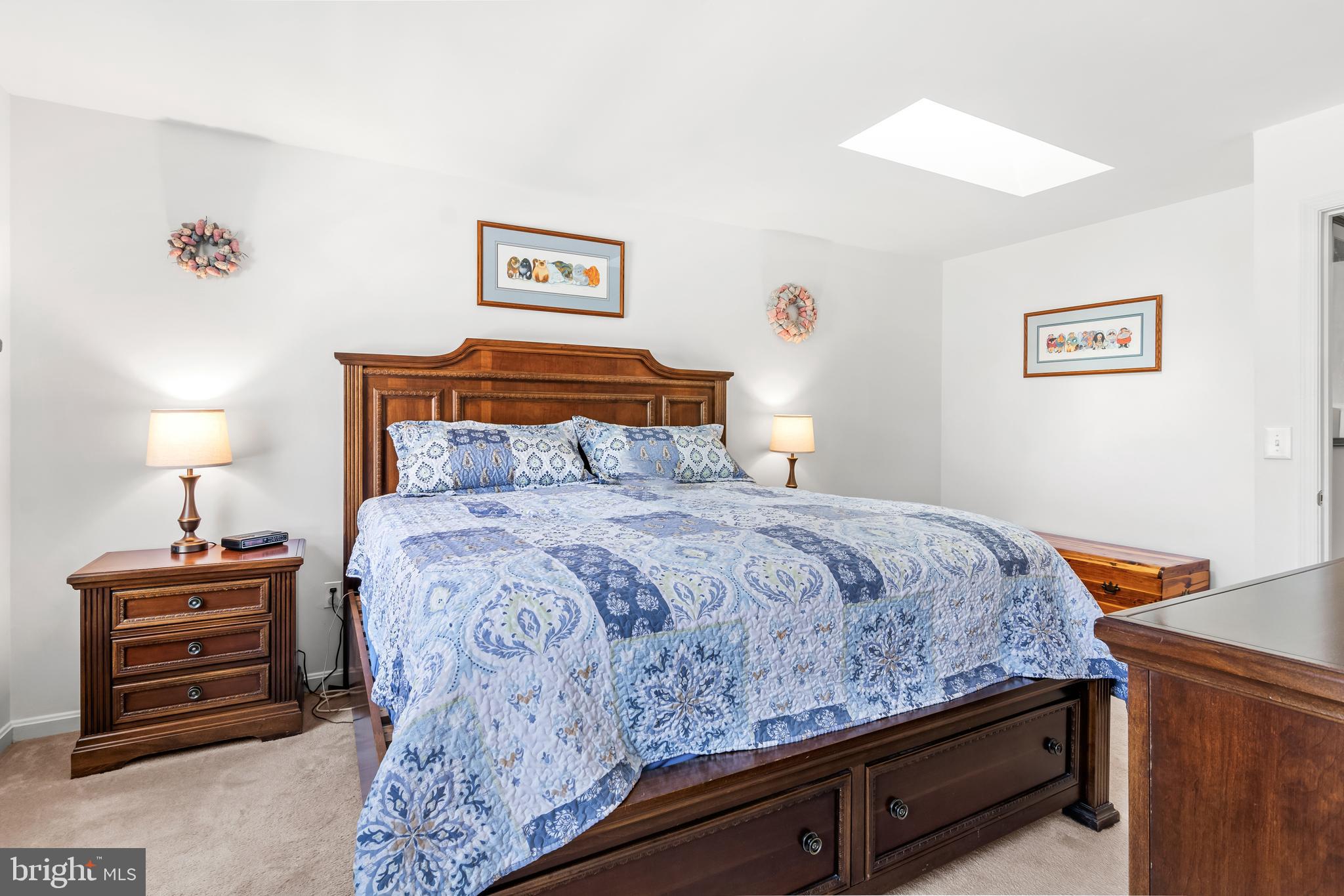 7866 Kings Bench Place Pasadena, MD 21122 - Photo 32 of 51 a bedroom with a bed and a lamp on a dresser