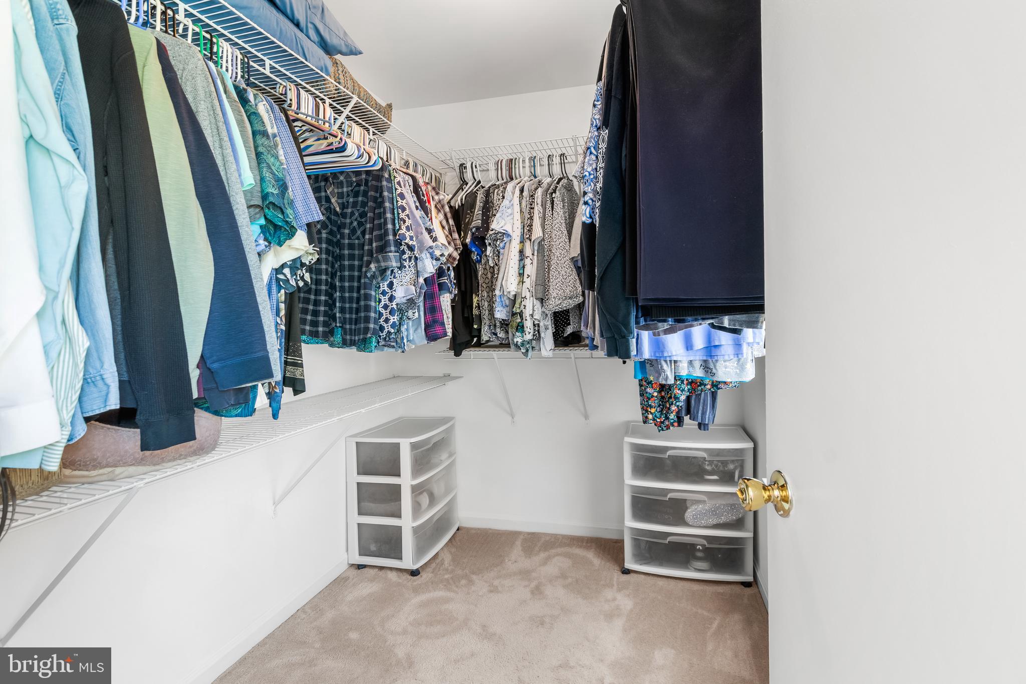 7866 Kings Bench Place Pasadena, MD 21122 - Photo 34 of 51 a view of walk in closet with clothes and shoes