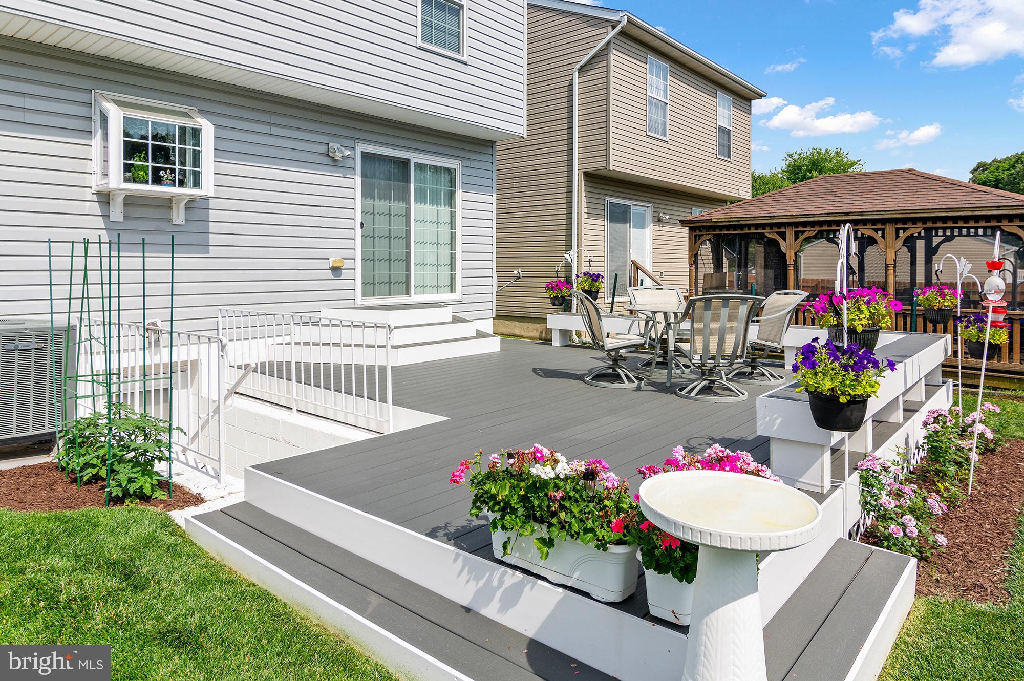 7866 Kings Bench Place Pasadena, MD 21122 - Photo 7 of 51 a view of a chairs and table in a patio