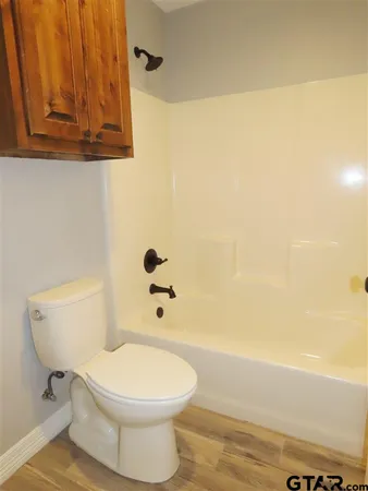 an empty room with closet and chandelier fan