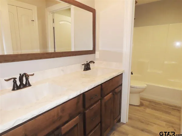 a view of bathroom with bathtub and wooden floor