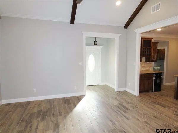 a large bathroom with a large mirror vanity and a shower
