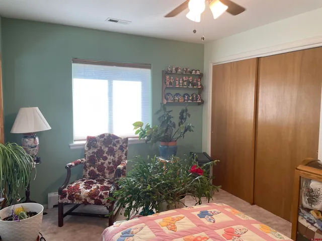 a bed room with a bed and a chandelier