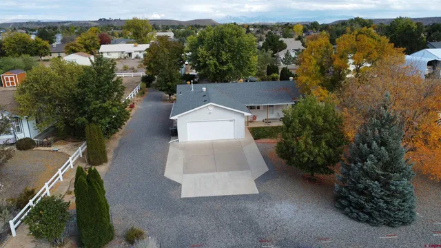 an aerial view of a house with a yard basket ball court