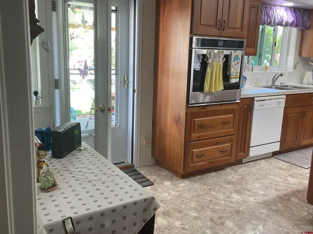 a kitchen with a refrigerator and dresser