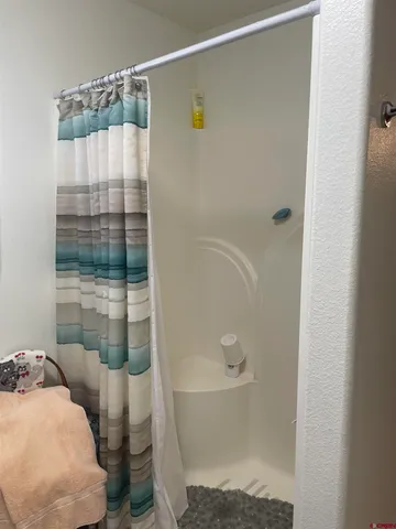 a bathroom with a bathtub and shower