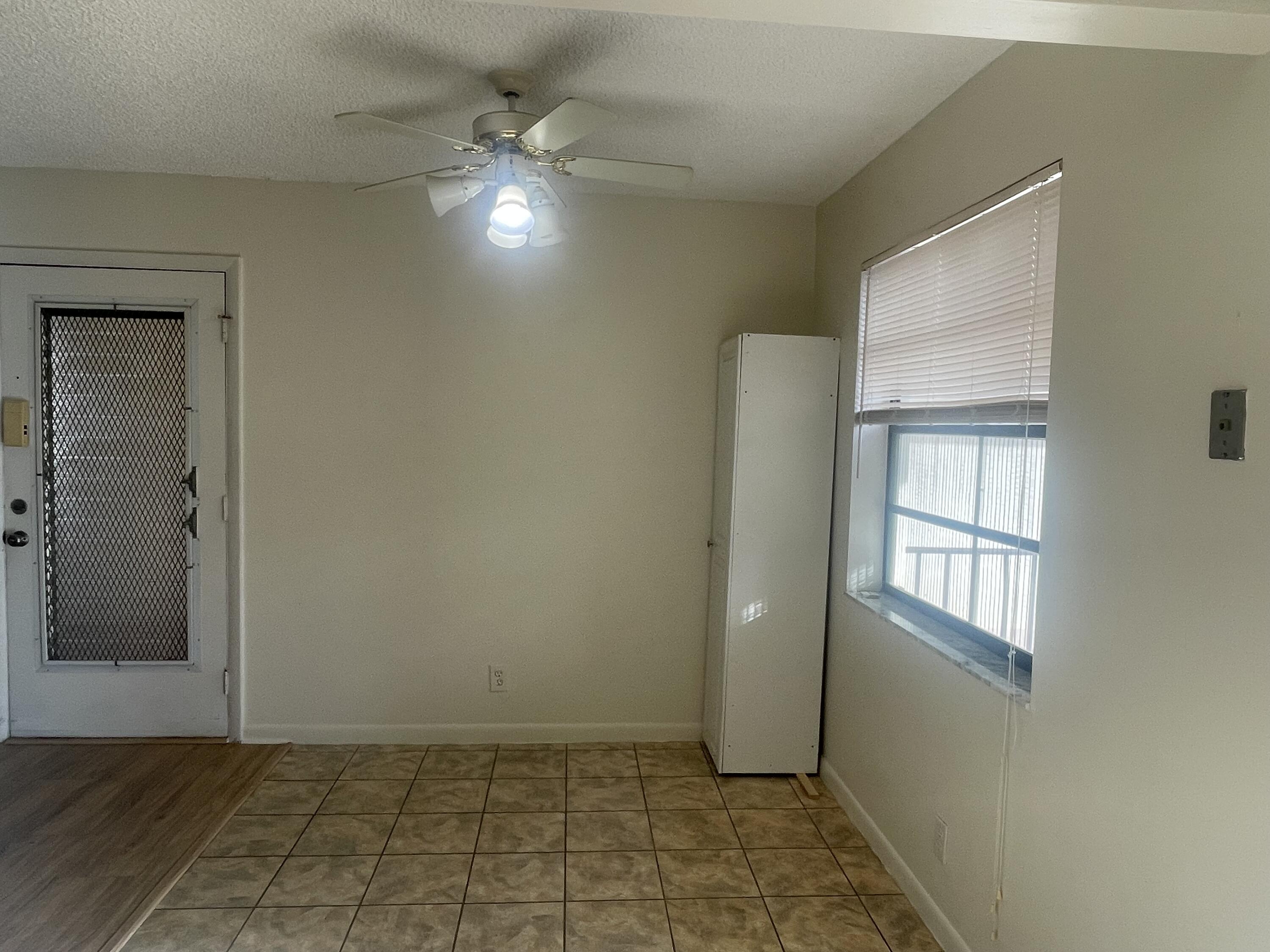 83 Capri B, Unit B Delray Beach, FL 33484 - Photo 4 of 26 an empty room with windows and closet