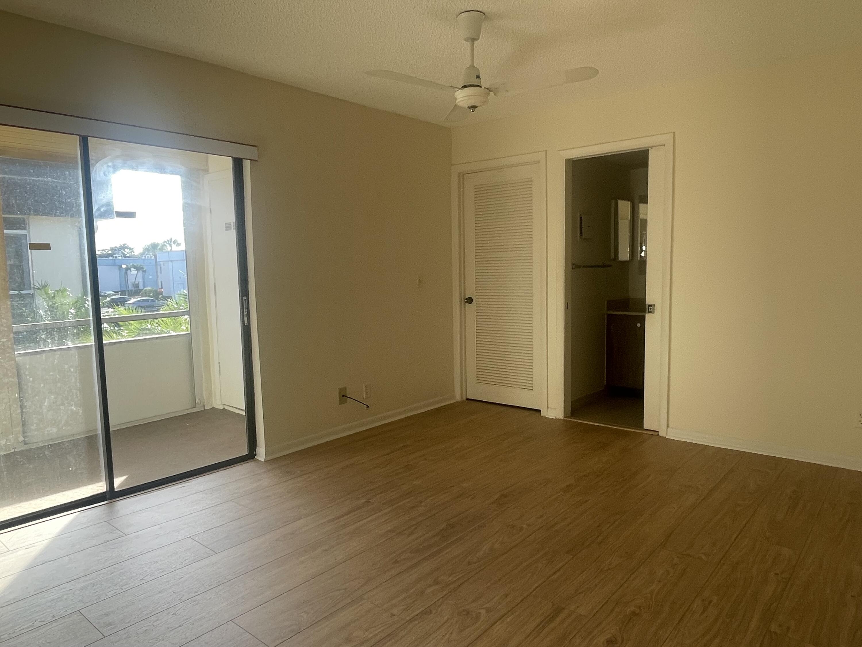 83 Capri B, Unit B Delray Beach, FL 33484 - Photo 9 of 26 a view of an empty room with glass door