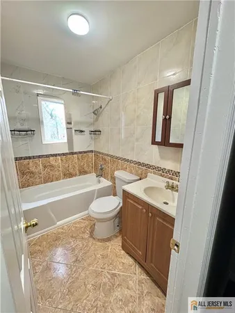 a bathroom with a sink a toilet and bathtub