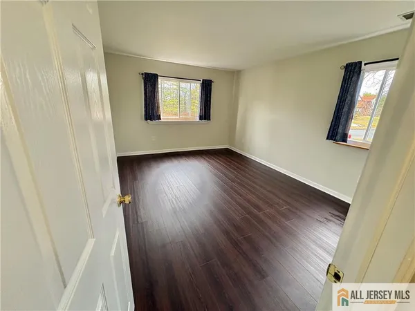 a view of a room with wooden floor and window