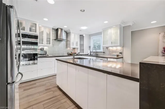 a kitchen with stainless steel appliances granite countertop a sink and cabinets