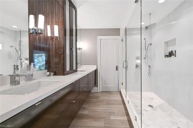 a bathroom with a double vanity sink and mirror