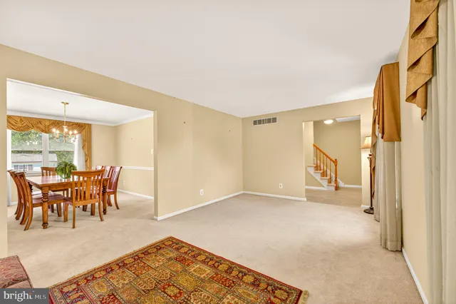 a dining room with furniture a chandelier and wooden floor