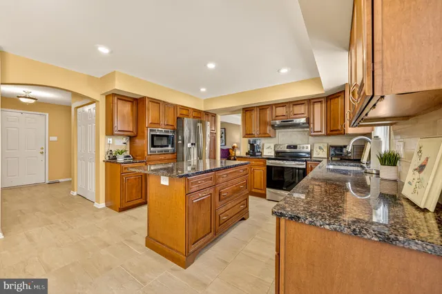 a view of a dining room with furniture and a chandelier